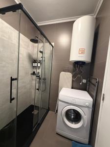 a washing machine in a bathroom with a lamp at Apartamento Barão in Amora +18 photos