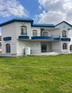 a large white house with a large yard at Almajidy Villa in Cairo