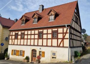 an old building with a red roof at Sethmacher Stube in Bad Gottleuba