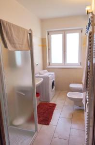 a bathroom with a sink and a washing machine at Casa Palmira in Drena +14 photos