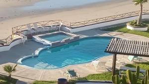 an overhead view of a swimming pool next to a beach at Summer Nights Oceanfront Villa - Pool & Jacuzzi in Primo Tapia