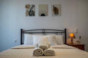 a bedroom with a bed with towels on it at Villa Papazoglou in Neos Pirgos +5 photos