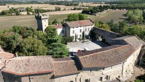 an aerial view of a building with a castle at Le Château de La Pomarède in La Pomarède