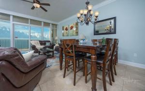 a living room with a dining room table and chairs at Phoenix Gulf Shores 1602 in Gulf Shores