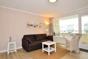 a living room with a couch and a table at Eydum, App 45 in Westerland