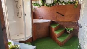 a bathroom with a tub and a sink and a toilet and a shower at Rattrays Rd Farm Accomodation in Makikihi
