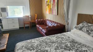 a hotel room with a couch and a bed at Rattrays Rd Farm Accomodation in Makikihi