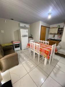 a kitchen and living room with a table and chairs at Casa de descanso, completa, para ate 05 pessoas in Pântano Grande