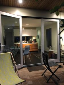 a living room with sliding glass doors and a dining room at Litehomeatseagoedereede in Goedereede