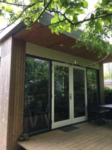 a screened in porch with sliding glass doors at Litehomeatseagoedereede in Goedereede