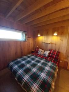a bedroom with a bed in a wooden cabin at Chalet charme et bien-être Jacuzzi et nature près de Durbuy in Durbuy +59 photos