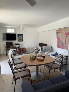 a living room with a table and chairs and a couch at ART BLUE Residence - Pool Access Apartment in Aghia Marina