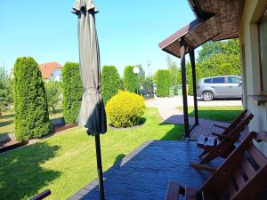 an umbrella sitting on a porch next to a house at luna in Gąski