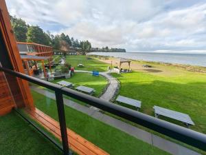 a balcony of a house with a view of the ocean at Sea Edge Beachside Hotel in Parksville