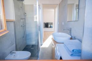 a bathroom with a sink and a toilet and a shower at Casa Simona in Dervio +21 photos