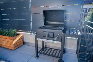 a barbecue grill on a cart on a patio at Casa Simona in Dervio