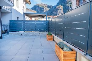 a patio with a blue fence and some plants at Casa Simona in Dervio