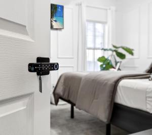 a room with a bed with a key on the door at The Executive Suite in McDonough