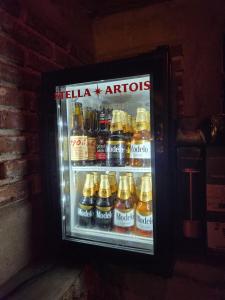 a refrigerator filled with lots of bottles of beer at Cabanas Madre Tierra Zacatlan in Cedro