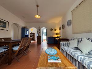 a living room with a couch and a table at Baglio La Luna - B&B in San Vito lo Capo