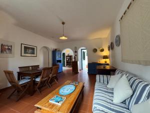 a living room with a couch and a table at Baglio La Luna - B&B in San Vito lo Capo