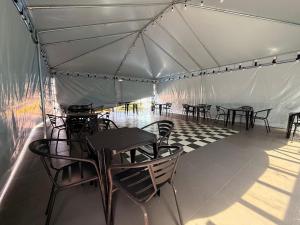 a group of tables and chairs in a tent at Hotel Mais Lazer - Hotel & Spa in Joinville