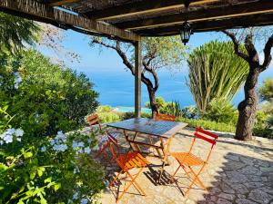 a wooden table and chairs on a patio at Baglio La Luna - B&B in San Vito lo Capo