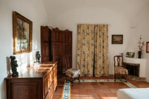 a living room with a dresser and a curtain at Villa Guya in Capri +58 photos