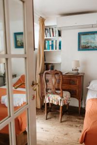 a bedroom with a desk and a chair and a bed at Villa Guya in Capri