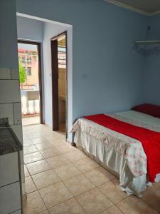a bedroom with a bed and a tiled floor at Hotel Avenida Paraísopolis MG in Paraisópolis +90 photos