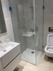 a bathroom with a shower and a sink and a toilet at Lux app ain zaghouen in Tunis