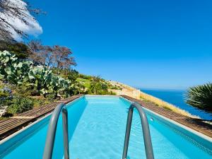 a pool with a view of the ocean at Baglio La Luna - B&B in San Vito lo Capo