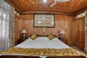 a bedroom with a bed and a painting on the ceiling at Alexandra Houseboats in Srinagar