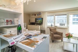 a living room with a table with a newspaper on it at Andreas-Dirks-Straße 1, App 505 "Pralinchen" in Westerland +9 photos