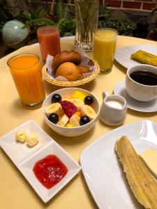 a table topped with plates of food and drinks at Chachapoyas Backpackers Hostal Boutique in Chachapoyas