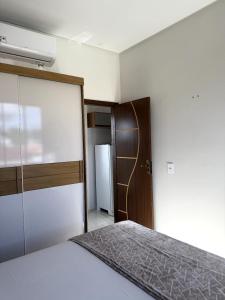 a small bedroom with a bed and a closet at Pousada & Flat Brandão - Canindé de São Francisco, SE in Canindé de São Francisco