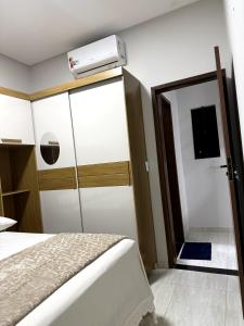 a bedroom with a bed and a air conditioner on the wall at Pousada & Flat Brandão - Canindé de São Francisco, SE in Canindé de São Francisco +3 photos