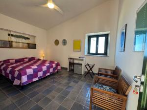 a bedroom with a bed and a desk in it at Baglio La Luna - B&B in San Vito lo Capo +62 photos