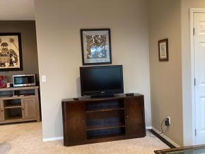 a living room with a flat screen tv on a cabinet at Five Oaks Retreat in Salem