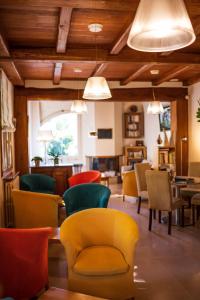 a room with chairs and tables and a room with ceilings at Hotel Restaurant de charme La Lozerette - Proche Florac in Cocurès