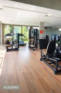 a gym with treadmills and elliptical machines at Apto com área de lazer estilo resort in Parnamirim