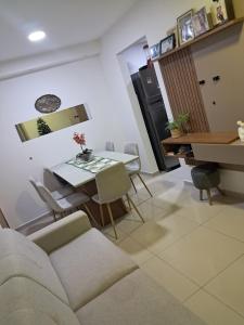 a living room with a couch and a table at Apto com área de lazer estilo resort in Parnamirim