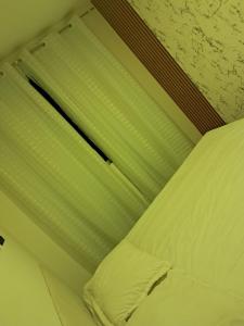 a bed in a room with a window with white sheets at Apto com área de lazer estilo resort in Parnamirim +21 photos