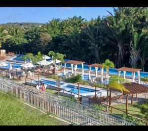 a resort with a pool with people walking around it at Apto com área de lazer estilo resort in Parnamirim