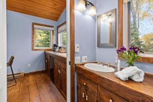 a bathroom with a sink and a mirror at Abode at Alpine Retreat in Wilson +56 photos