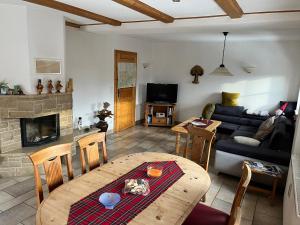 a living room with a table and a couch at Ferienhaus Miriquidi Perle in Marienberg