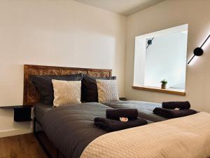 a bedroom with a bed with two pillows on it at LYMA Suites - Apartment G2 in Immenstadt im Allgäu