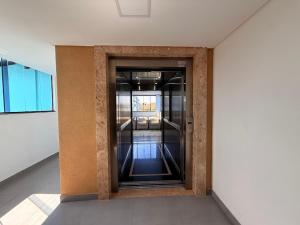 a hallway with an elevator in a building at Hotel Mais Lazer - Hotel & Spa in Joinville