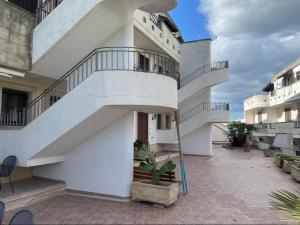 a white building with stairs on the side of it at terrazza acquaviva in Marittima