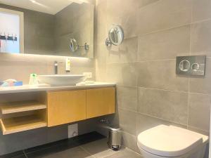 a bathroom with a sink and a toilet at Ferienwohnung Bergzauber mit Balkon & Bergblick in Schliersee